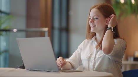 Focused-redheaded-woman-distance-teacher-online-tutor-wear-headphone-conferencing-on-laptop-communicate-with-student-by-webcam-video-call-chat-explain-course-help-e-learning-computer-education-concept
